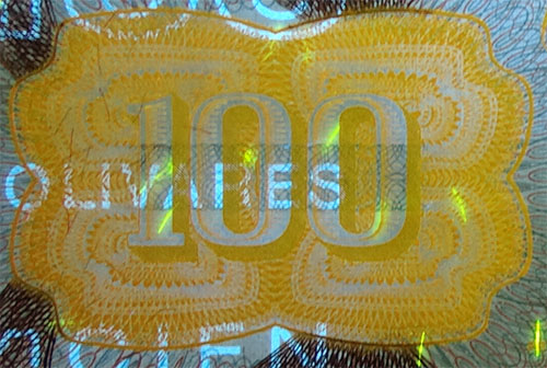 Piece bbcv100bs-dc01-h8 (Obverse, partial, under ultraviolet light)